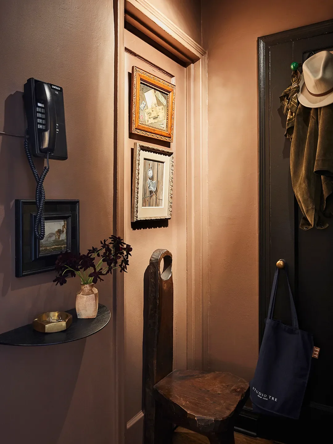 I can put coats on the door and there’s a little place to put my keys. Then I hung art on the door that led to the bedroom. | Paint color, Cola byFarrow & Ball.