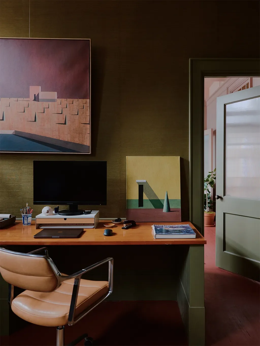 Crimson Floors and Curated Hardware Define a Design Studio’s Collected Character