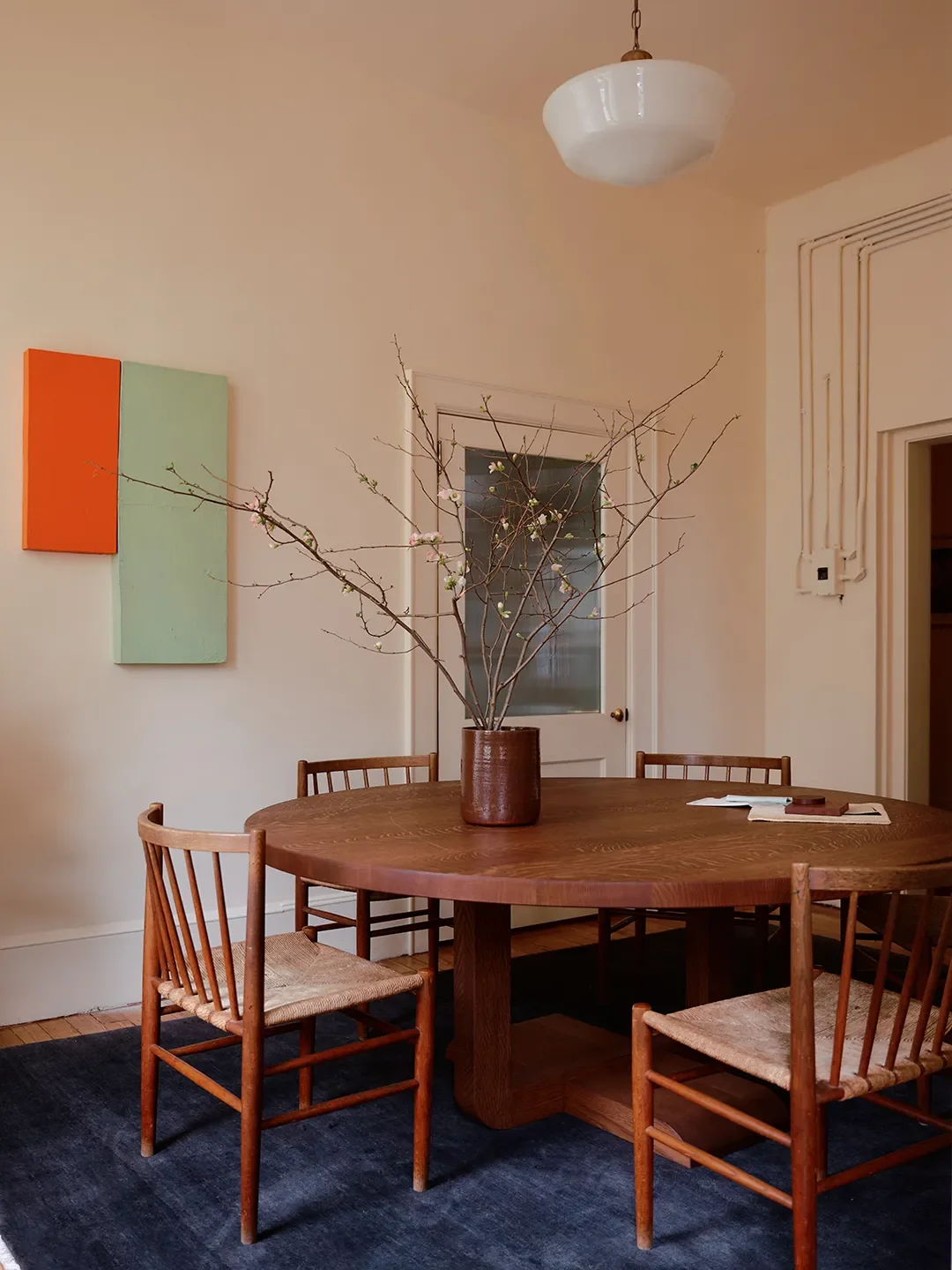 The meeting room. When asked about the roomy vintage chairs, Steif proclaimed: “We got a screaming deal on Live Auctioneers.” | Alpern Round Dining Table,Fern; Rug,Armadillo; Paint,Tallowby Farrow & B