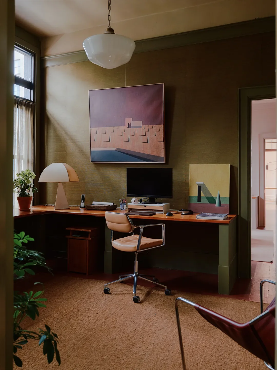 Zames and Steif’s offices. Rug,Armadillo; 453 Swivel Chair,Vipp; Grasscloth wallpaper,Elitis; Paint,DibberandCordby Farrow & Ball; Table lamp,Danny Kaplan Studio; Artwork,Ramon Enrichfrom Amelie du Ch