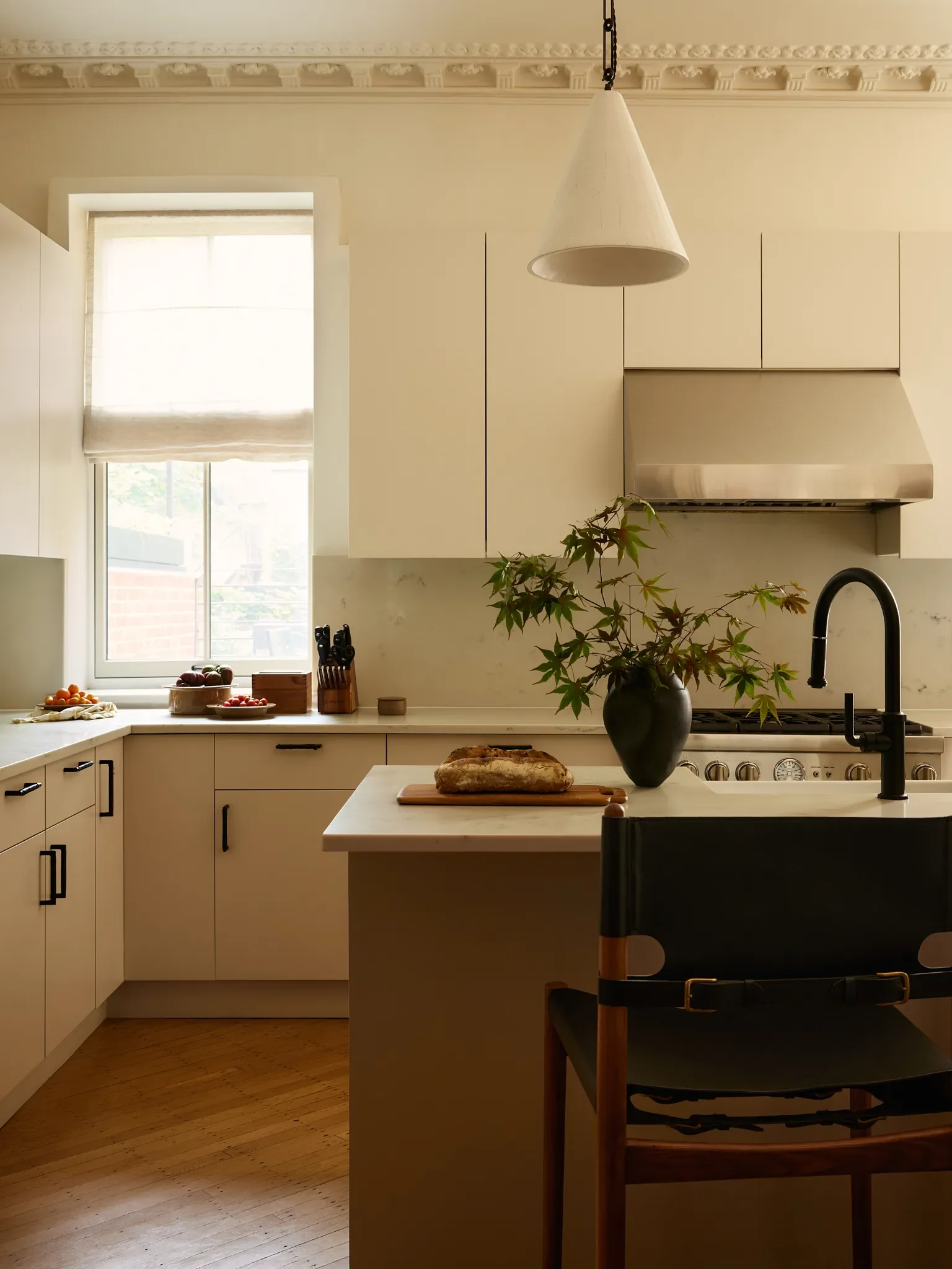The minimalist kitchen was a retrofit that the client may revisit down the line. In the meantime, it doesn’t compete, or attempt to replicate, the historic grandeur, but rather subtly enhances the ove