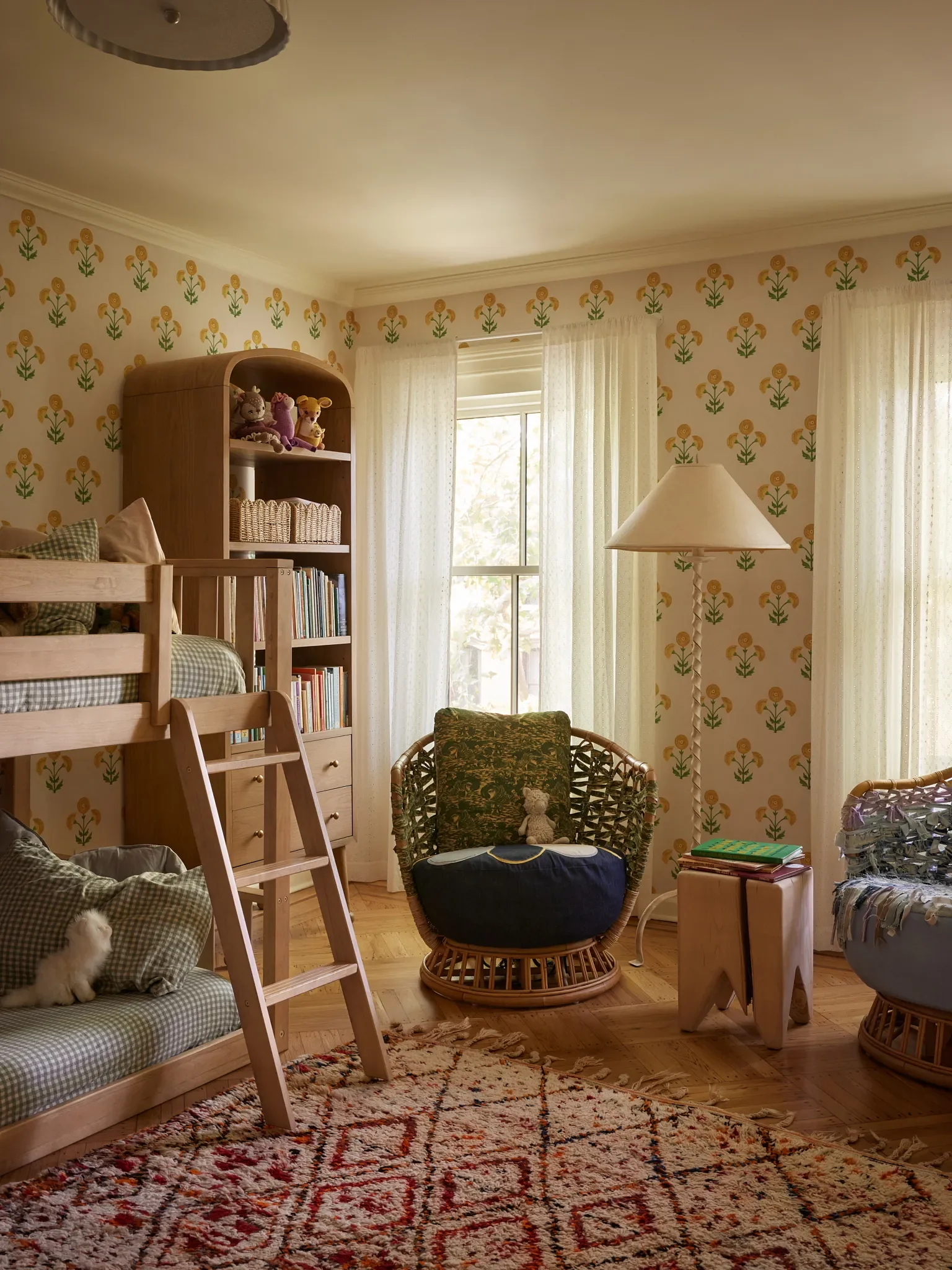 Crucially, the design both in the bathroom and the kids’ rooms are capable of evolving with only minor tweaks over time. | Wallpaper,Saranda Flower Sisalby Schumacher; Moretti Oak Bookcase,Anthropolog